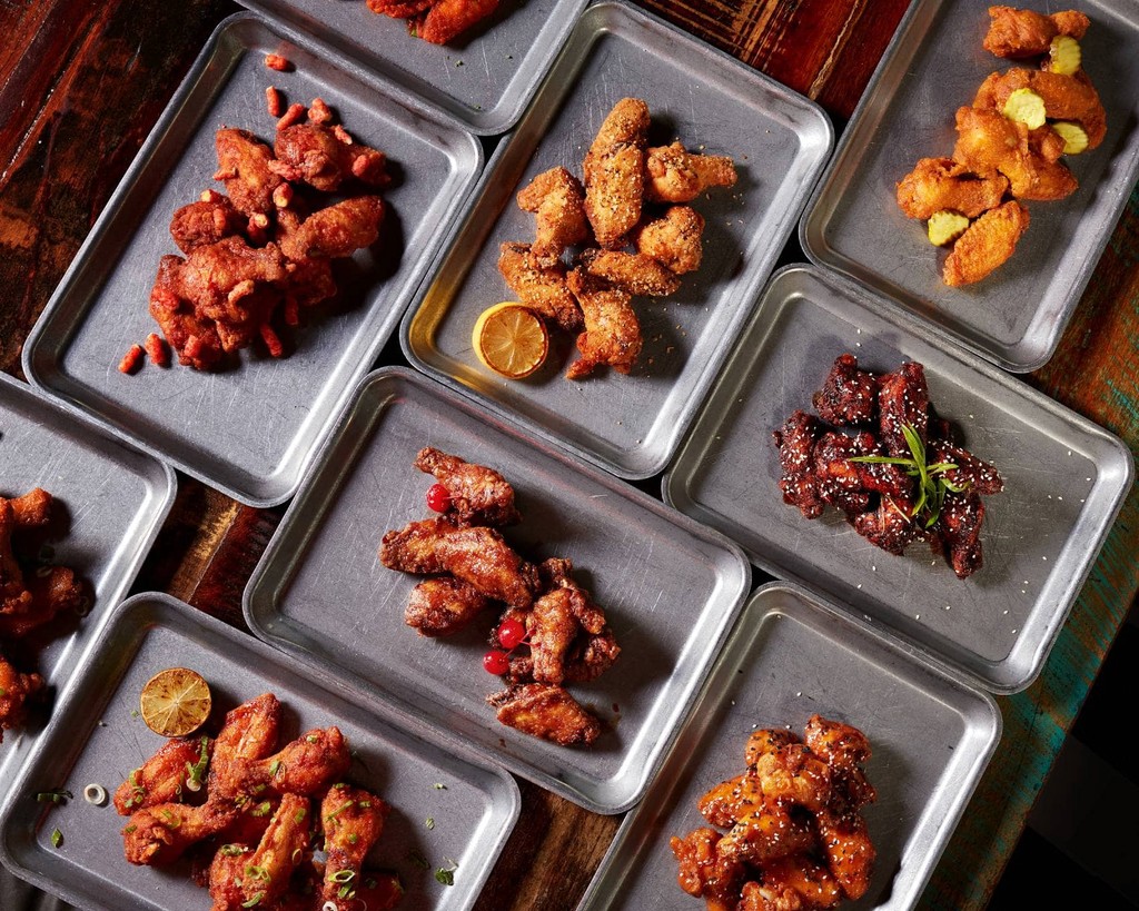 Table filled with chicken wing platters