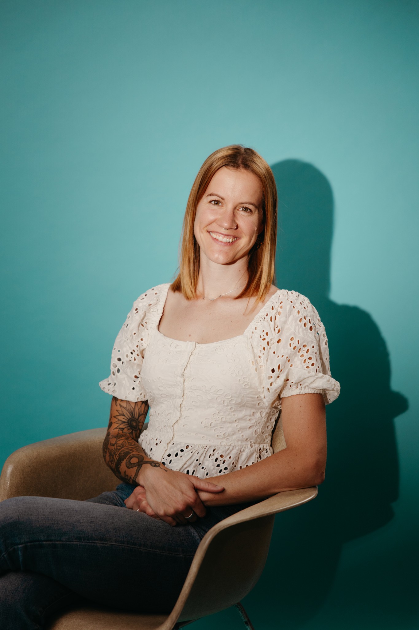 Headshot of Valerie on a turquoise backdrop