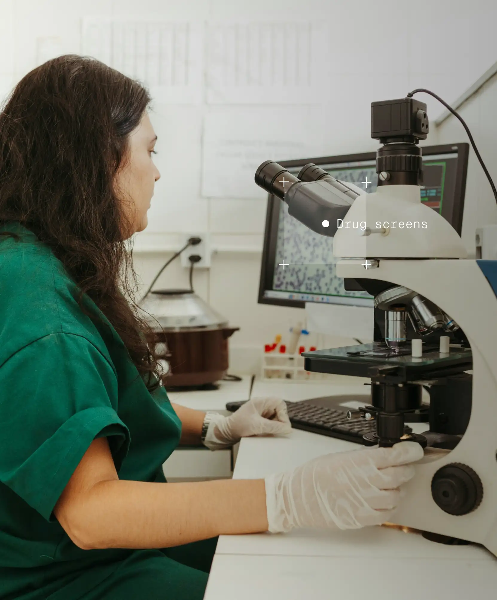 Woman looking at microscope of drug screens