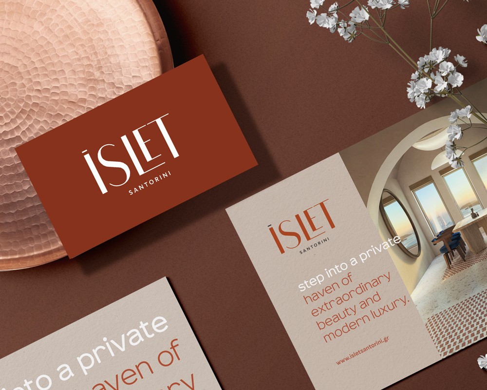 ISLET Santorini brand identity applied to business cards and printed materials, featuring natural textures and earthy tones