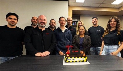 Avant Constructions and Plexa teams behind a cake