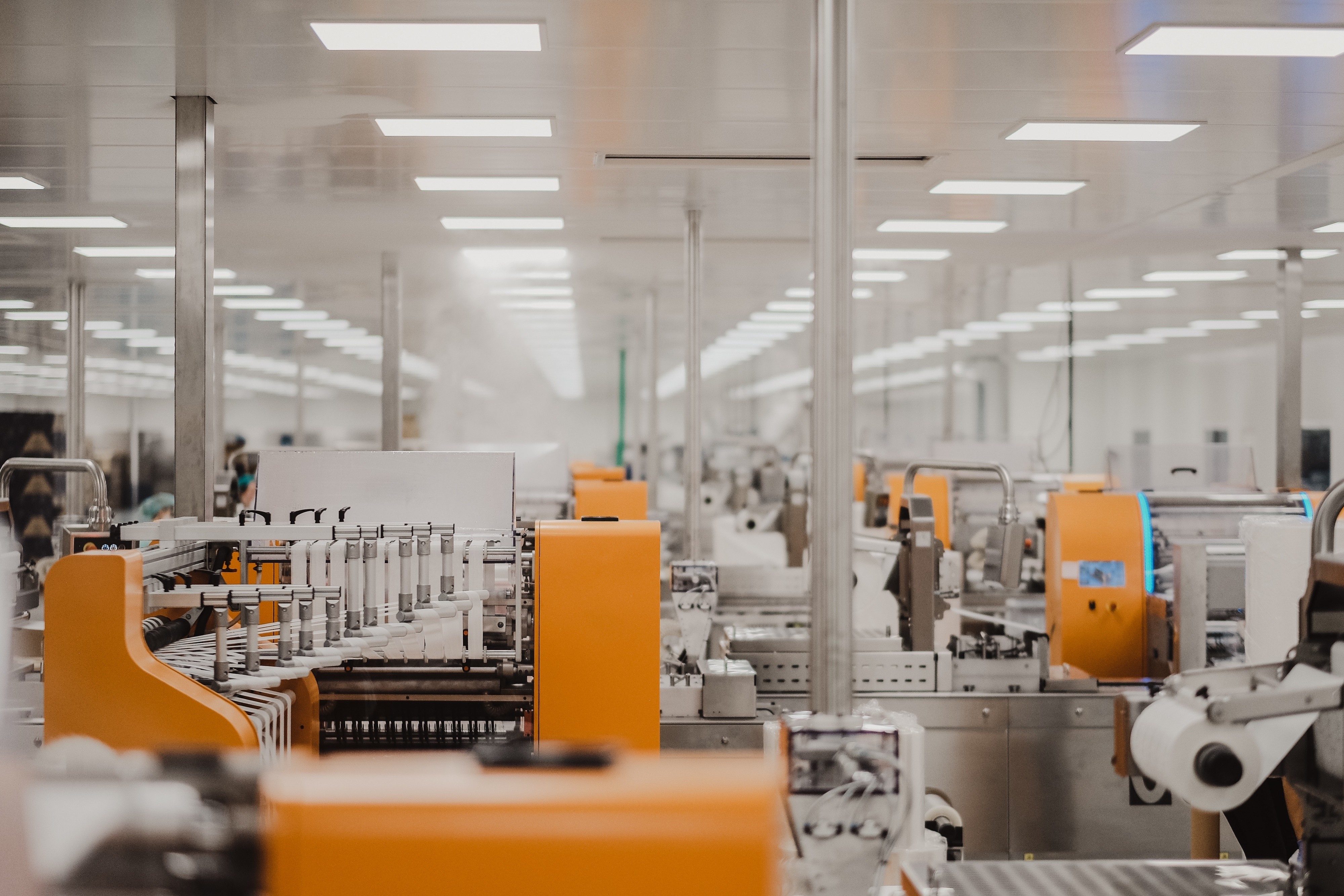 Industrial packaging production floor with multiple high-speed packaging machines in operation, the kind of shop floor environment the modernized platform serves.