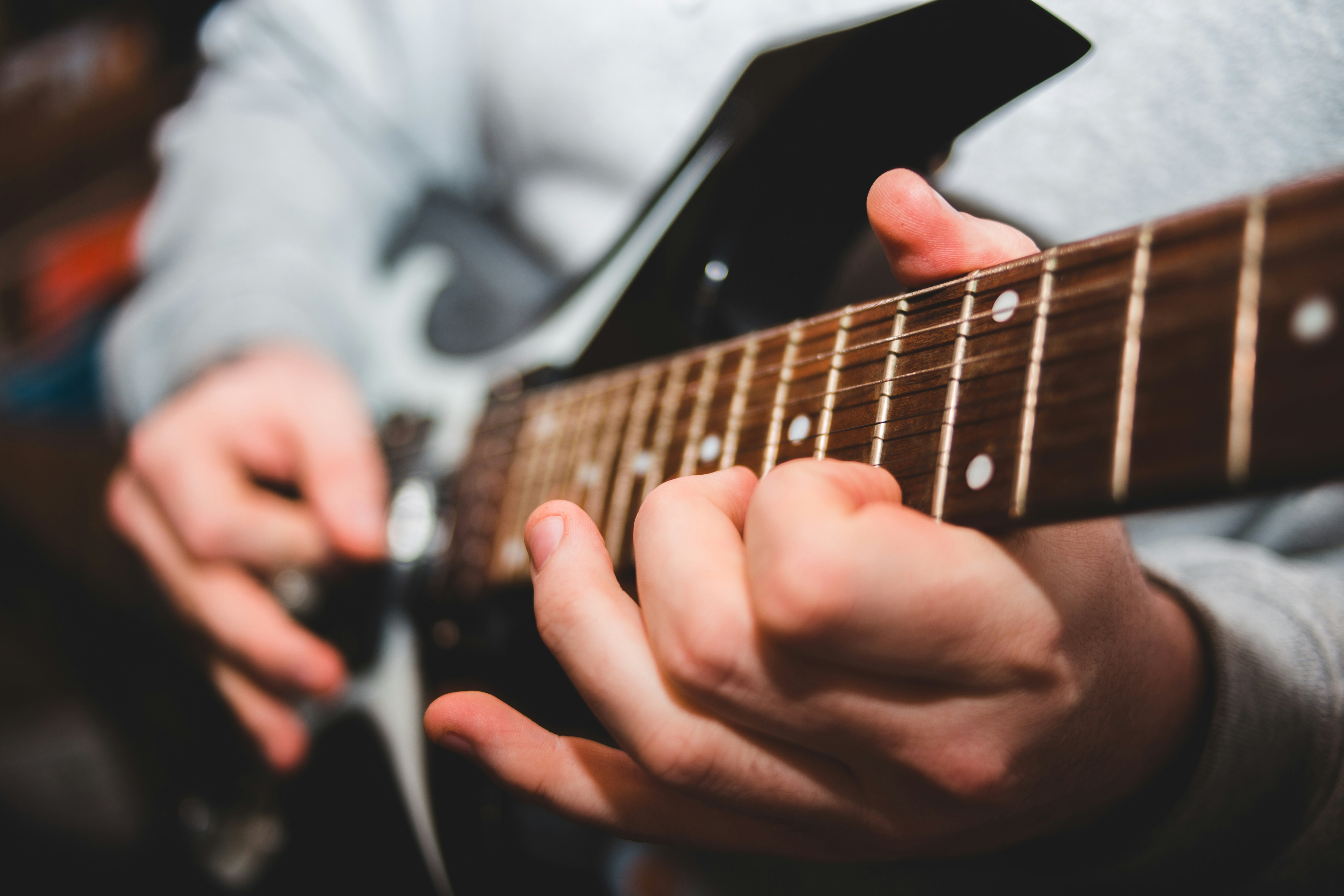 Man fretting a guitar