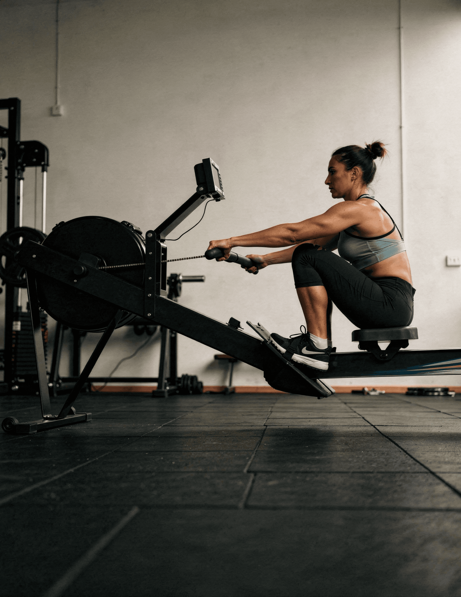Woman using rowing machine in gym workout session