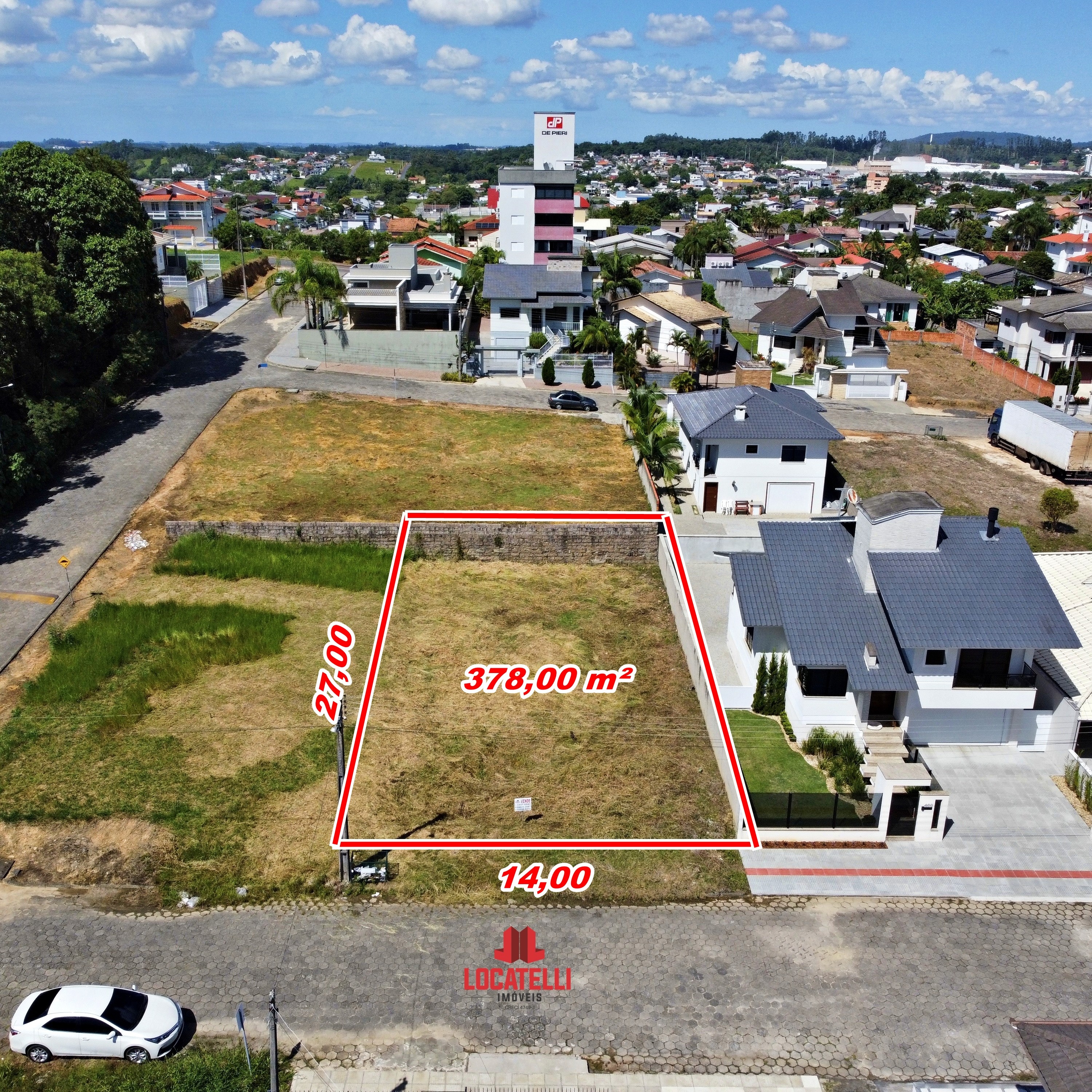 A modern brick house with a two-car garage, well-manicured lawn, and clear blue sky in the background.