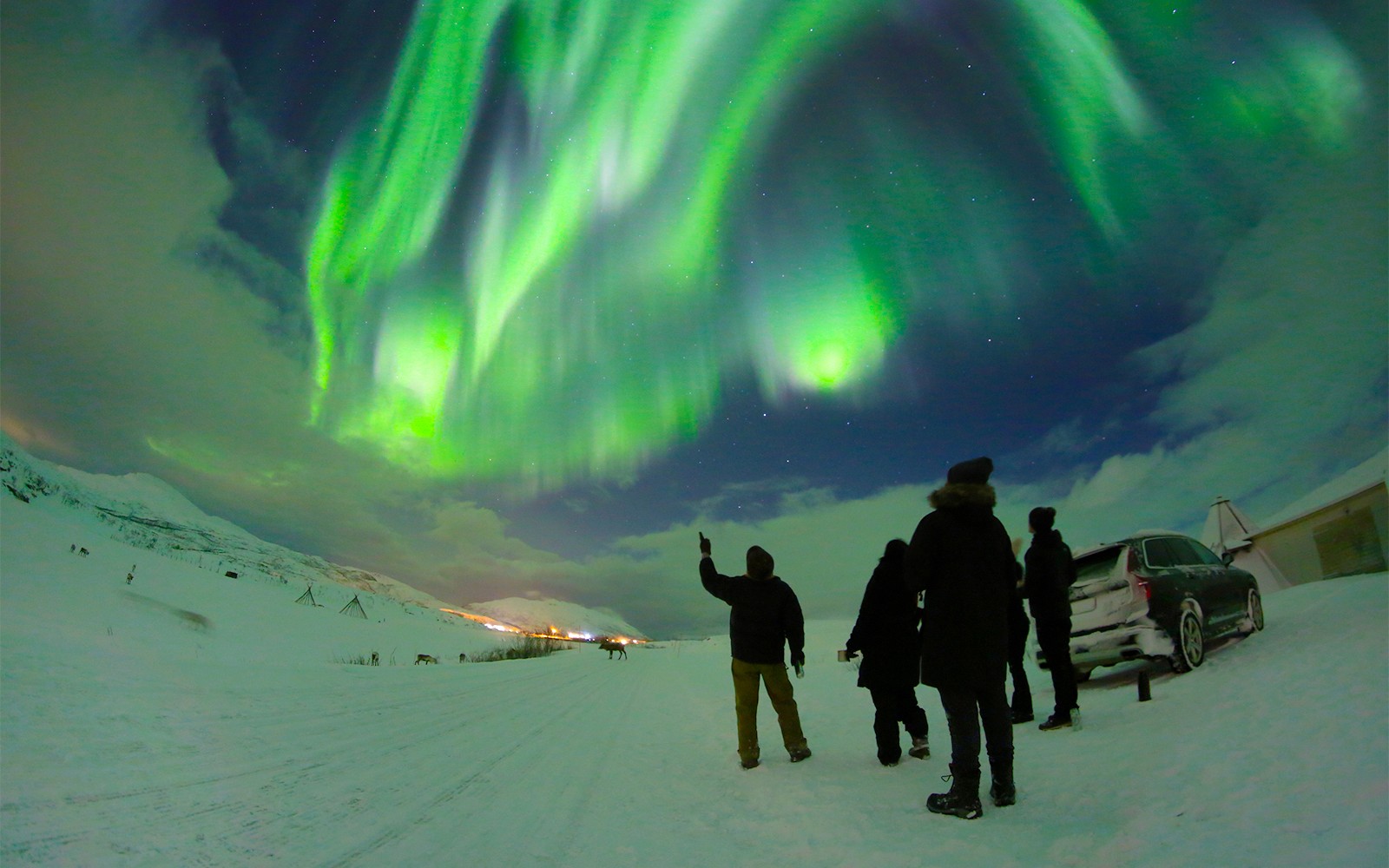 People watching Northern Lights with guide in Tromso, Norway.