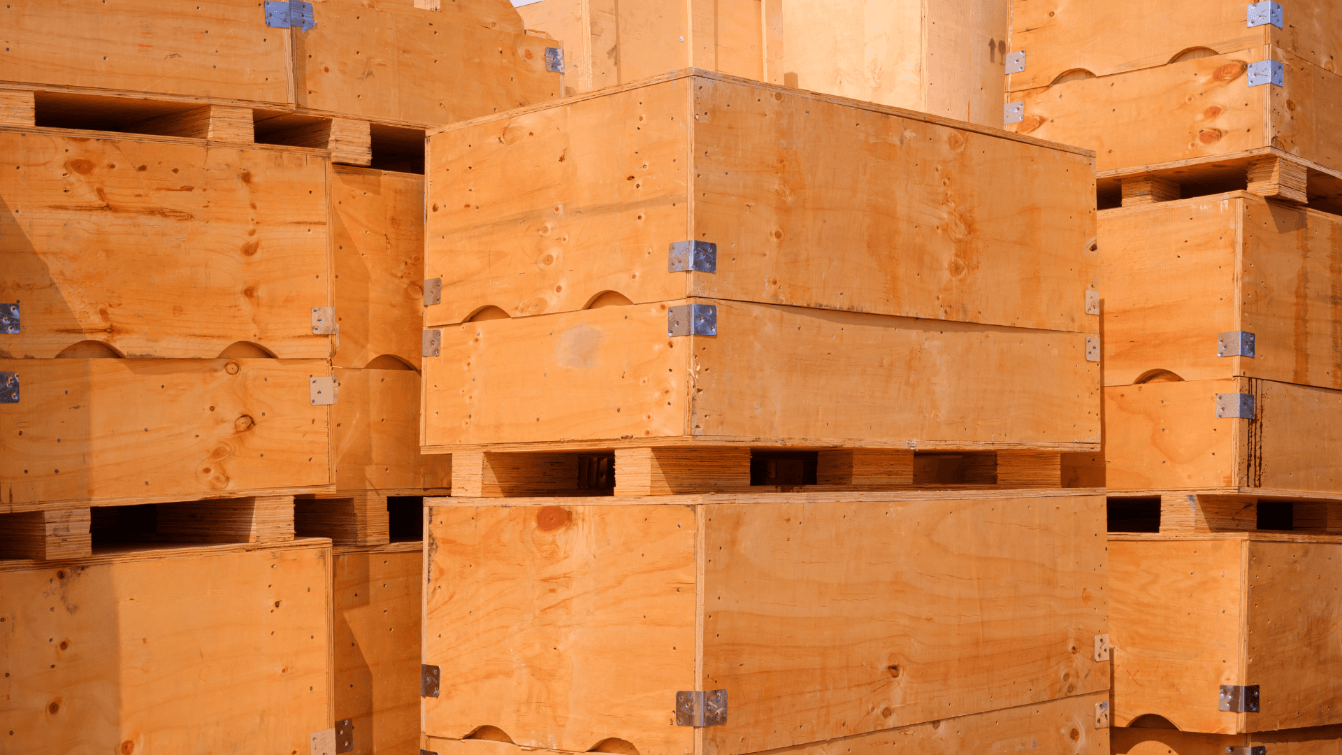 Stacked heavy-duty wooden shipping crates stored in a warehouse.