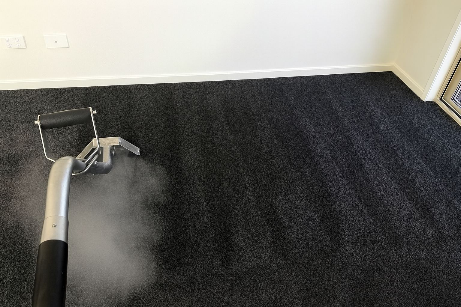 Woman vacuuming floor while listening to music.