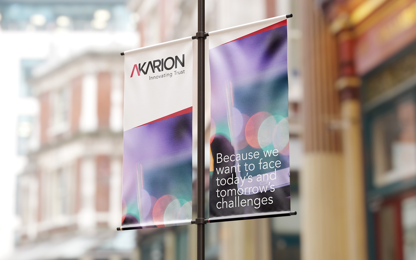 Two branded posters hanging on a pole.