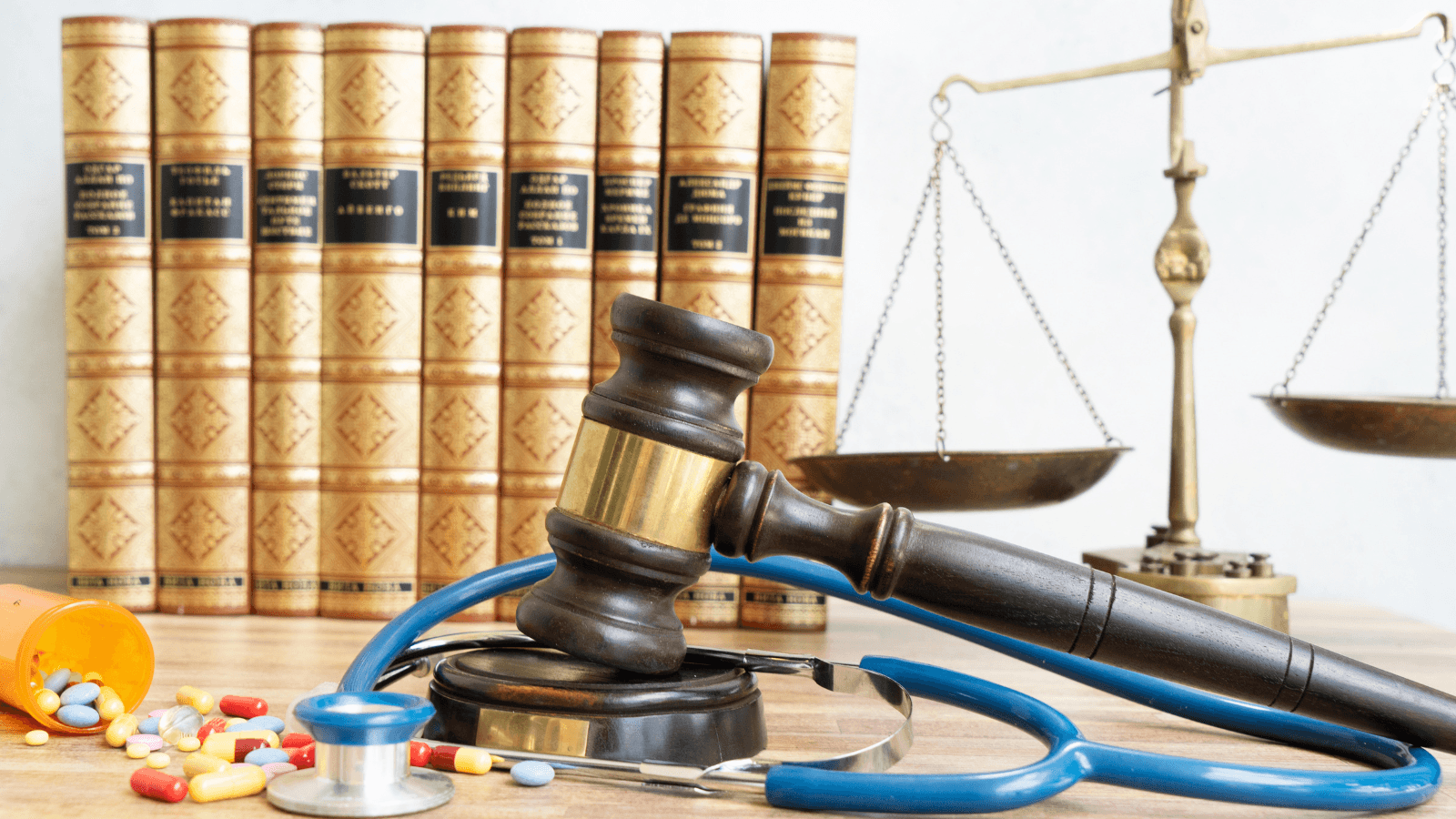 Legal and medical symbols with law books in the background, representing the best bookkeeper firms for medical clinics in the USA.