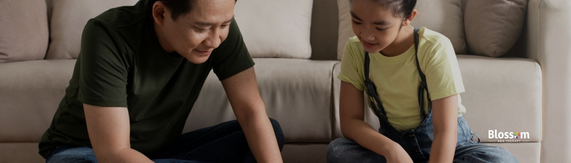 A father and daughter working on a craft project with colorful paper and supplies.