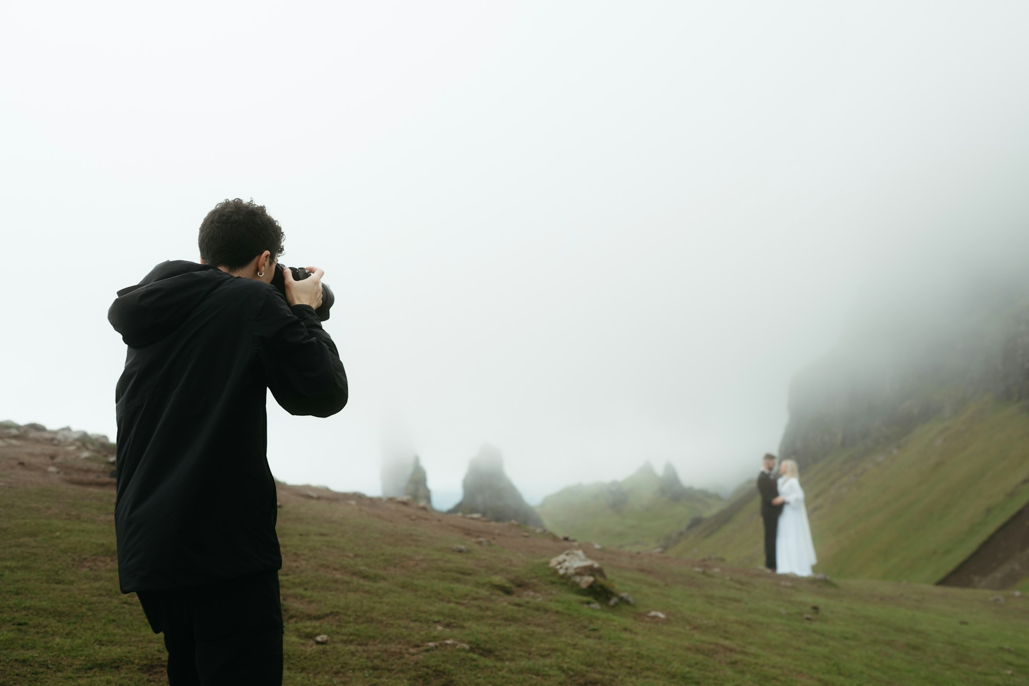 A filmmaker with a camera in the morning mist