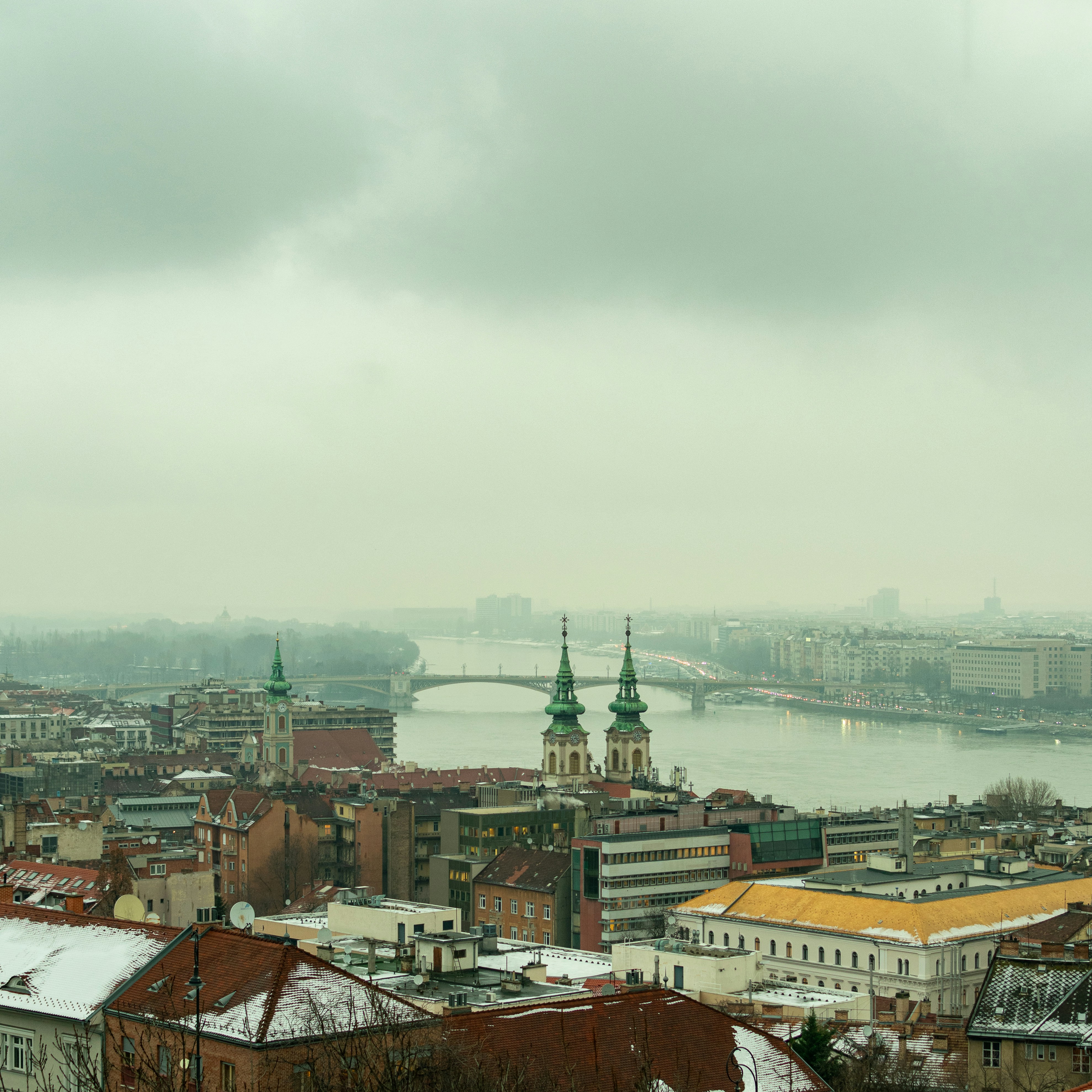 a view of a city with a bridge in the background