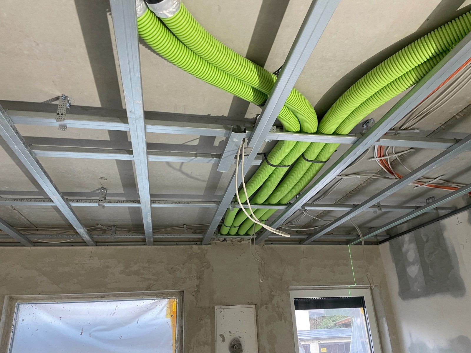 Montage von Lüftungsleitungen für eine dezentrale Wohnraumlüftung mit Wärmerückgewinnung in einem sanierten Einfamilienhaus.