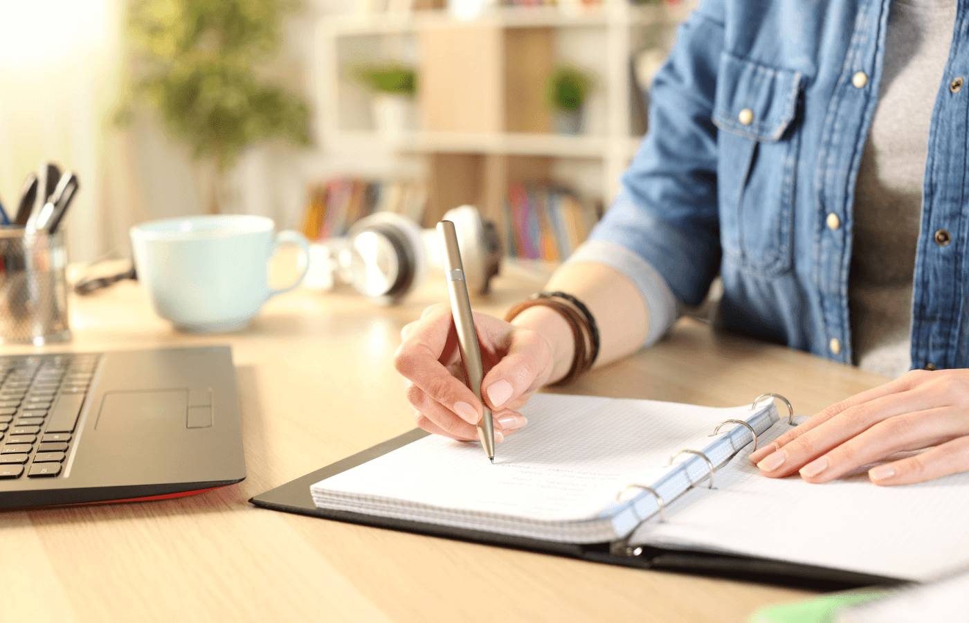 girl hand writing on notebook at home