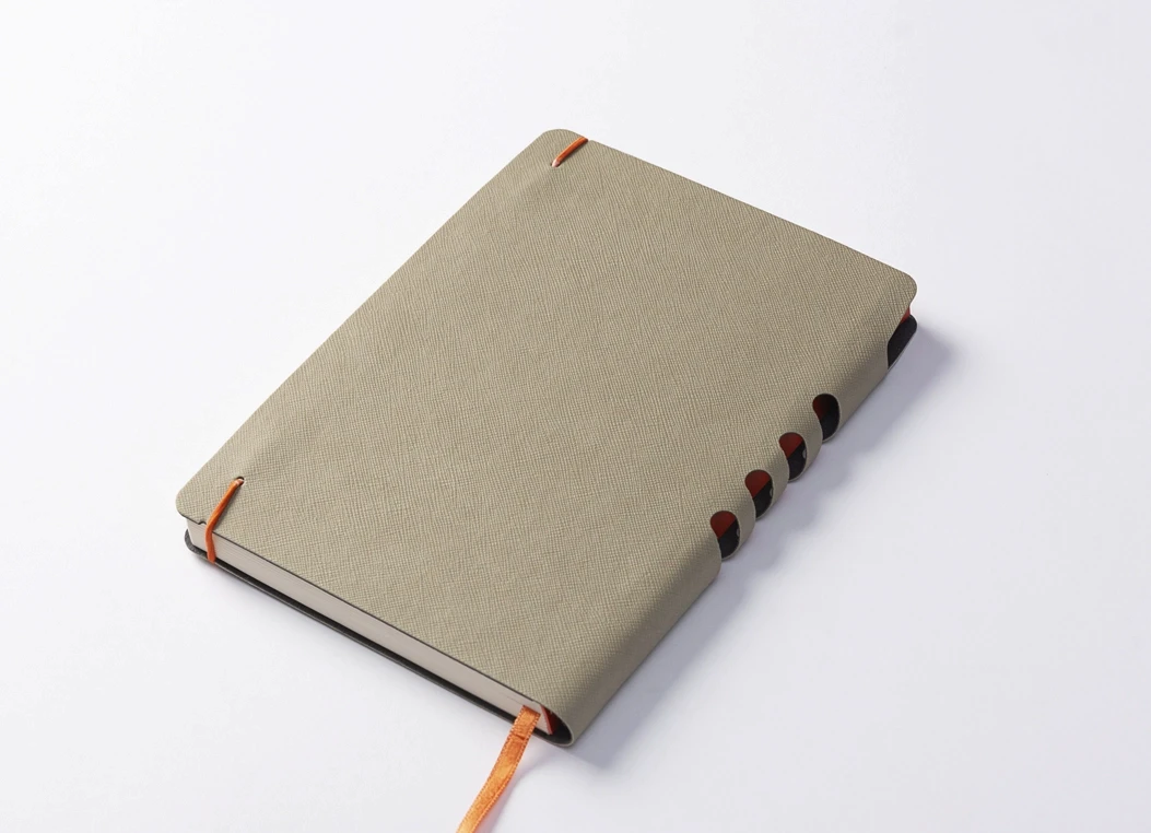 Fabric-covered journal with orange elastic closure and ribbon bookmark