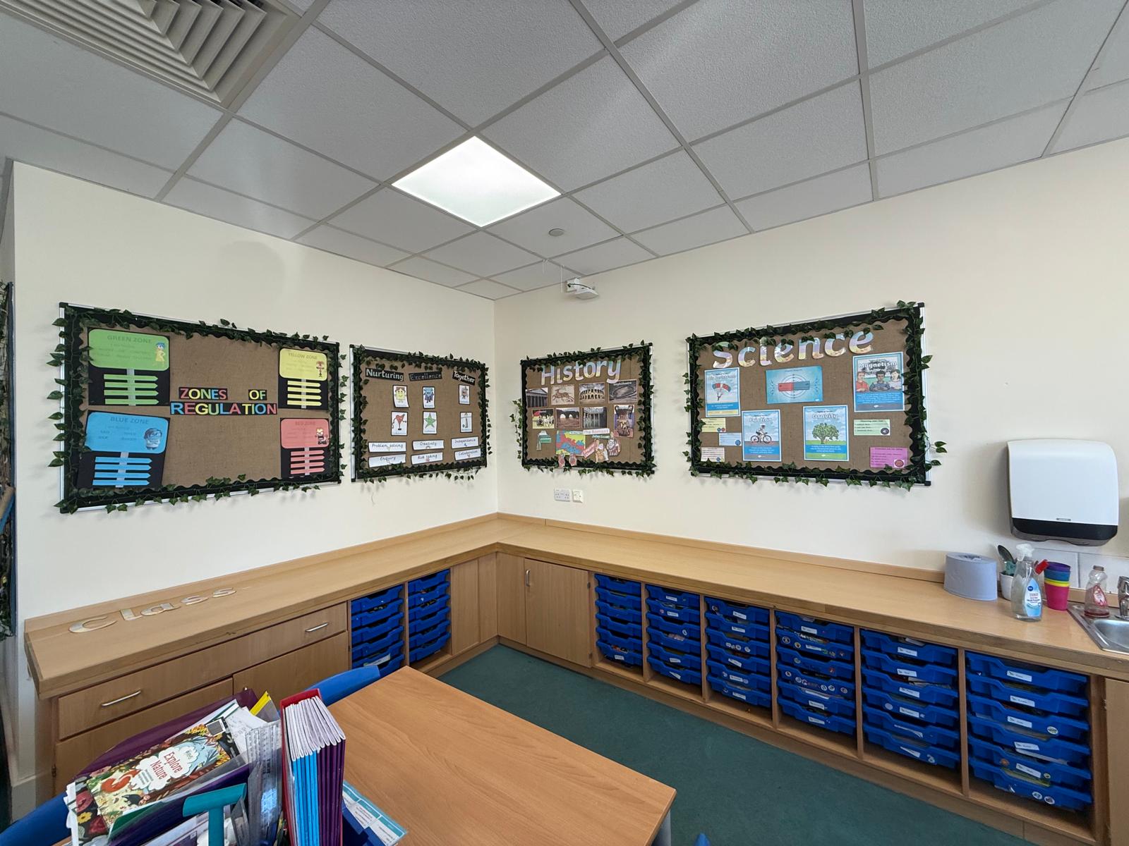 Rooftop garden with trees and plants, overlooking a cityscape at sunset with a tall building in the background