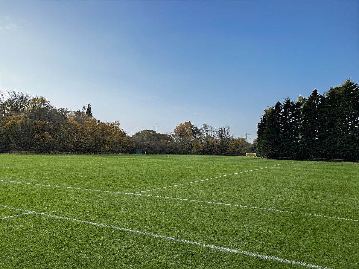 aerial photography of person trimming sports field during day