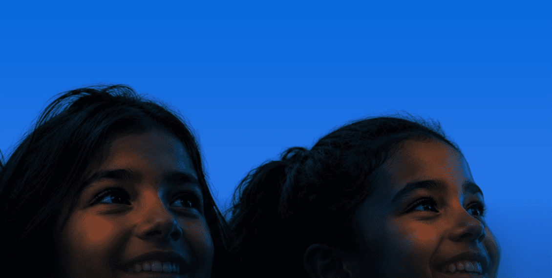 Students looking up, lit in blue