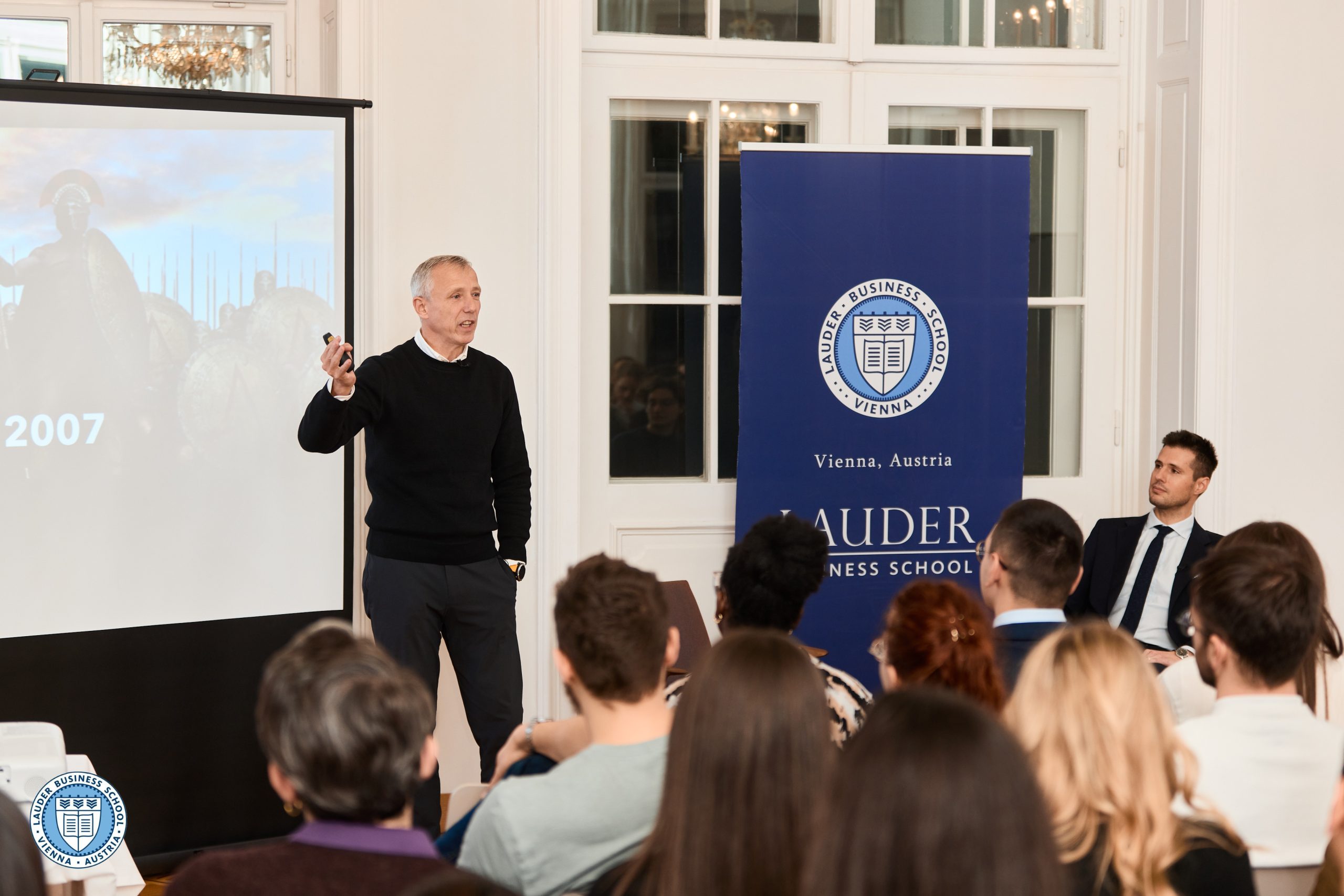 Presenter speaking to a group of students in a classroom setting