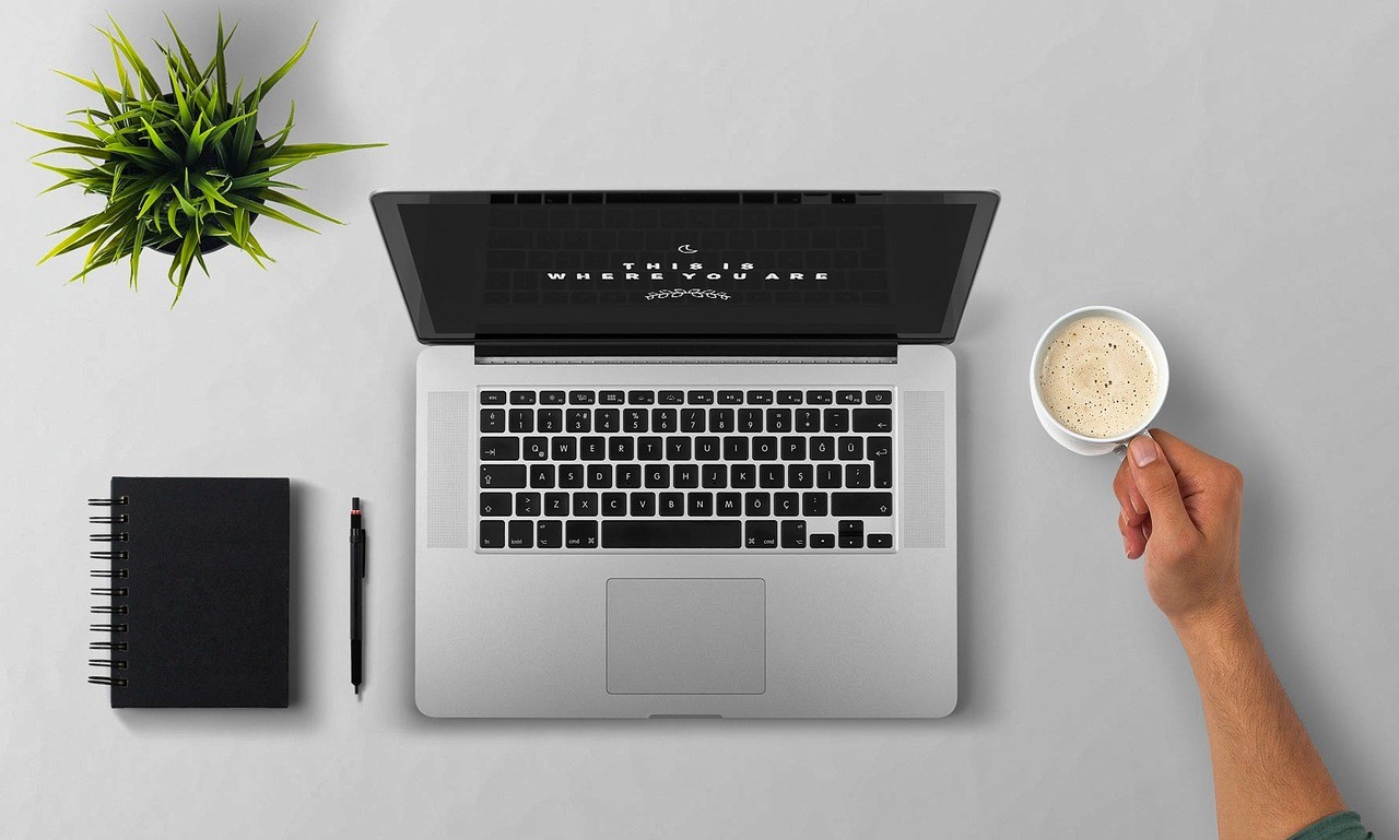 Laptop with coffee cup | IDIGIU - Digital Marketing Agency
