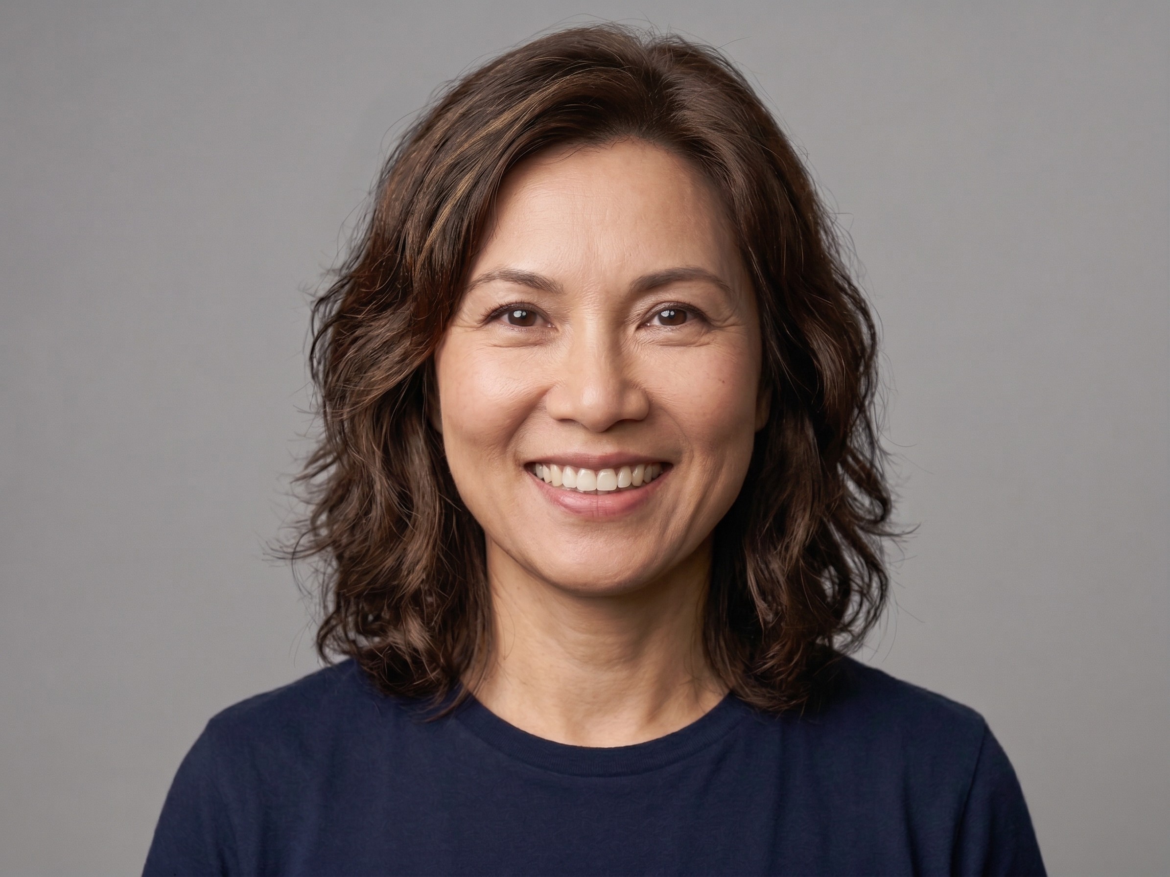 A person smiling and looking serious.