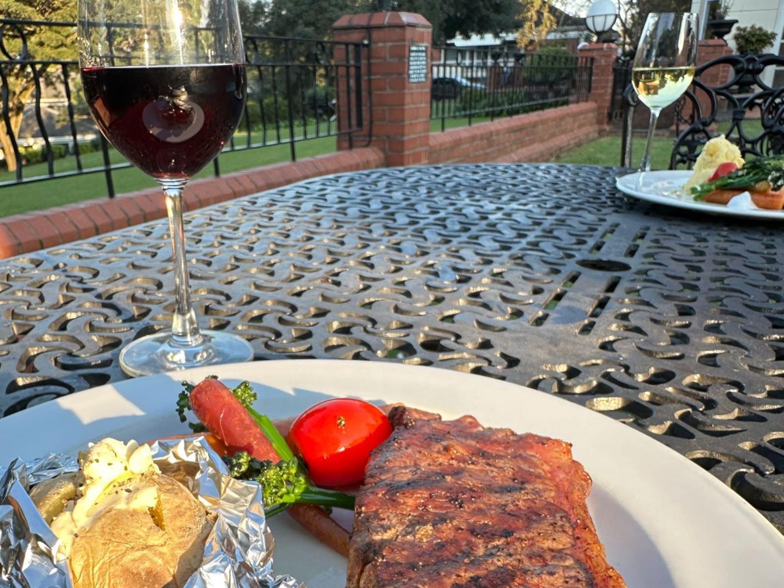 Outdoor terrace dining at Redlands Restaurant with views of the gardens.