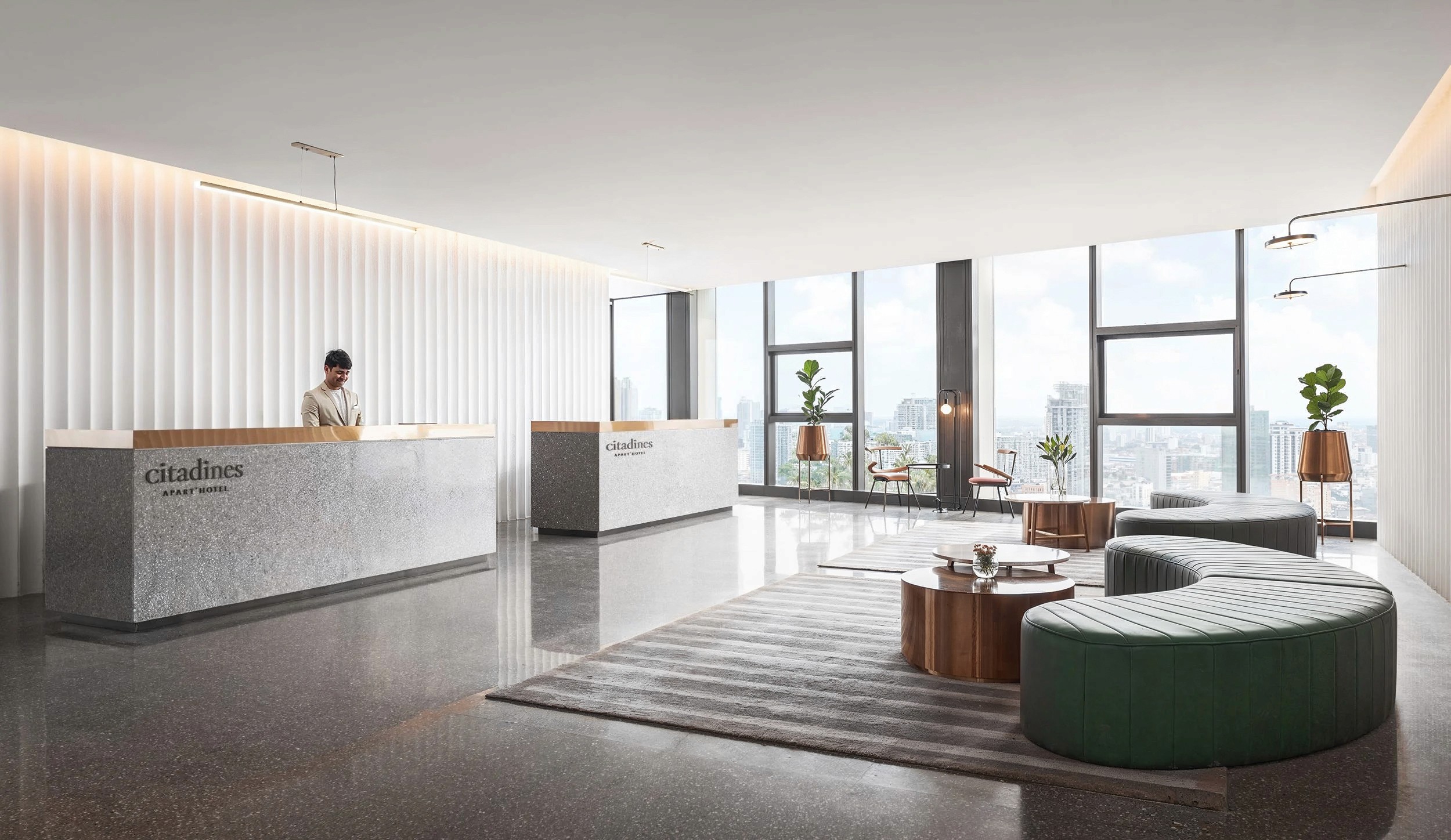 Modern hotel lobby interior design, minimalist stone reception desks, fluted white wall panels.