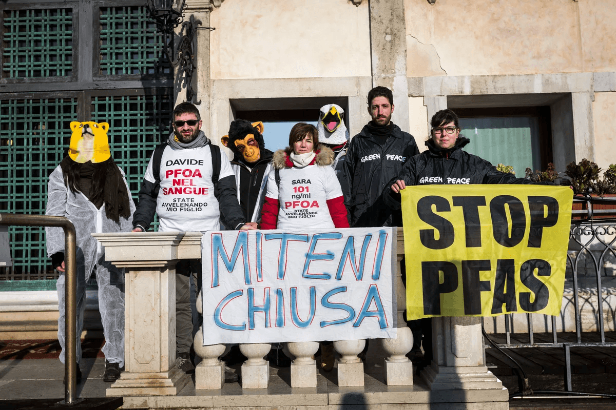 man in orange and black vest wearing white helmet holding yellow and black power tool