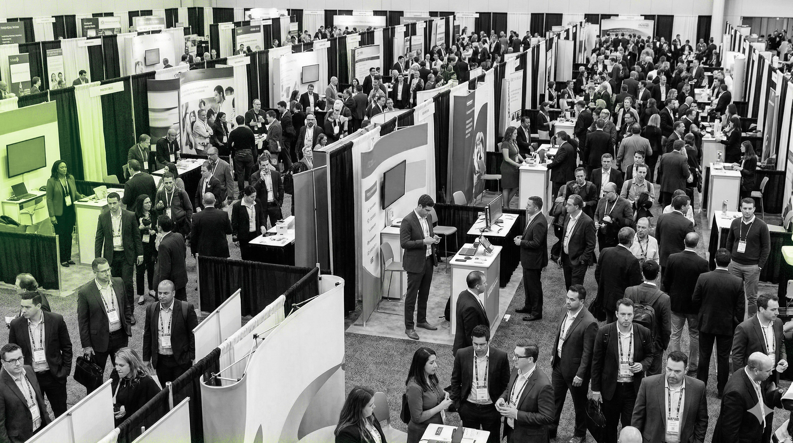 Busy convention hall with exhibition booths and professionals networking at a trade show.