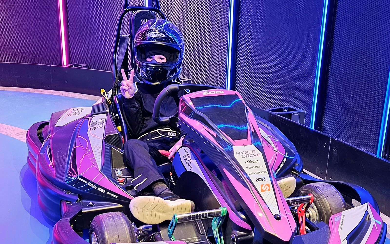 Driver in full racing gear in go kart at Hyperdrive in Singapore