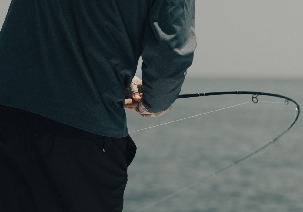 Angler holding a bent fly fishing rod