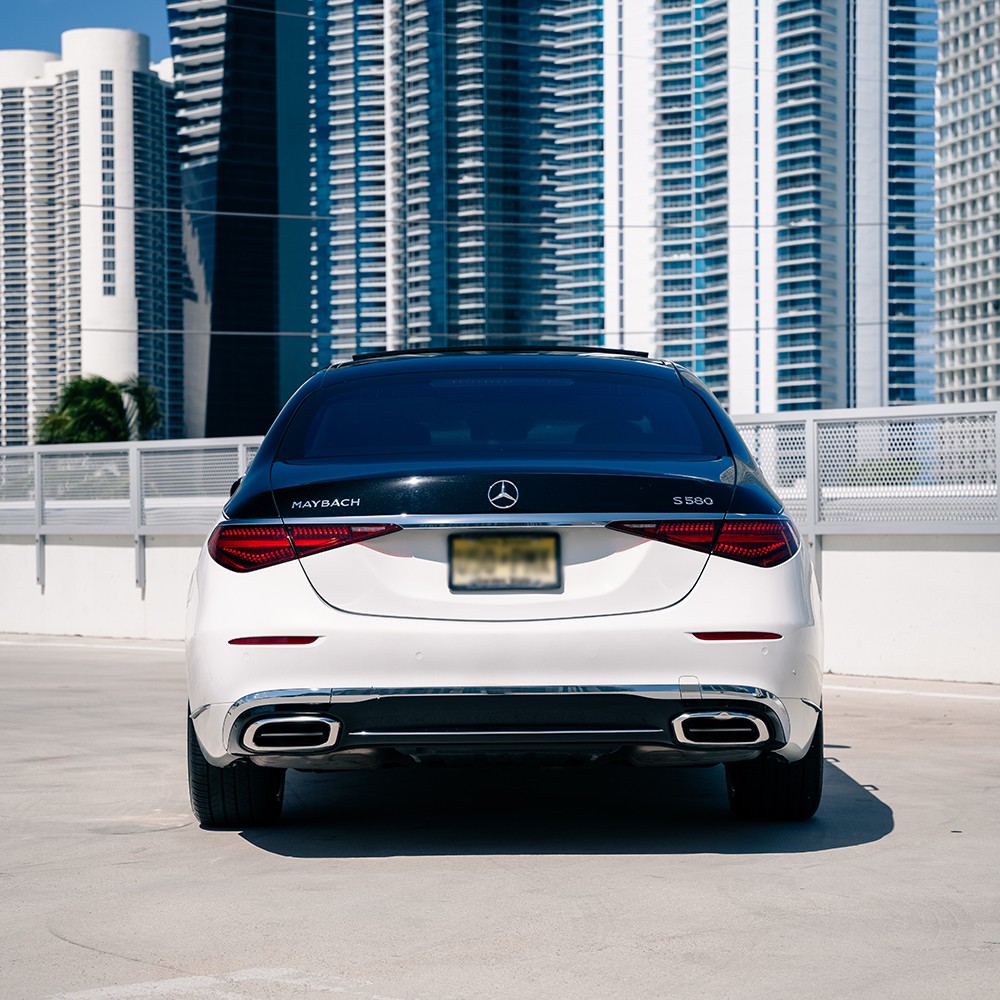 Rear view of the two-tone Mercedes-Maybach S580, highlighting its sleek taillights and Maybach badging.