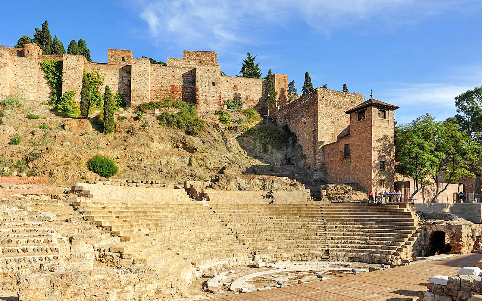 Roman Theater and Alcazaba in Málaga, Spain, with ancient stone seating and fortress walls.