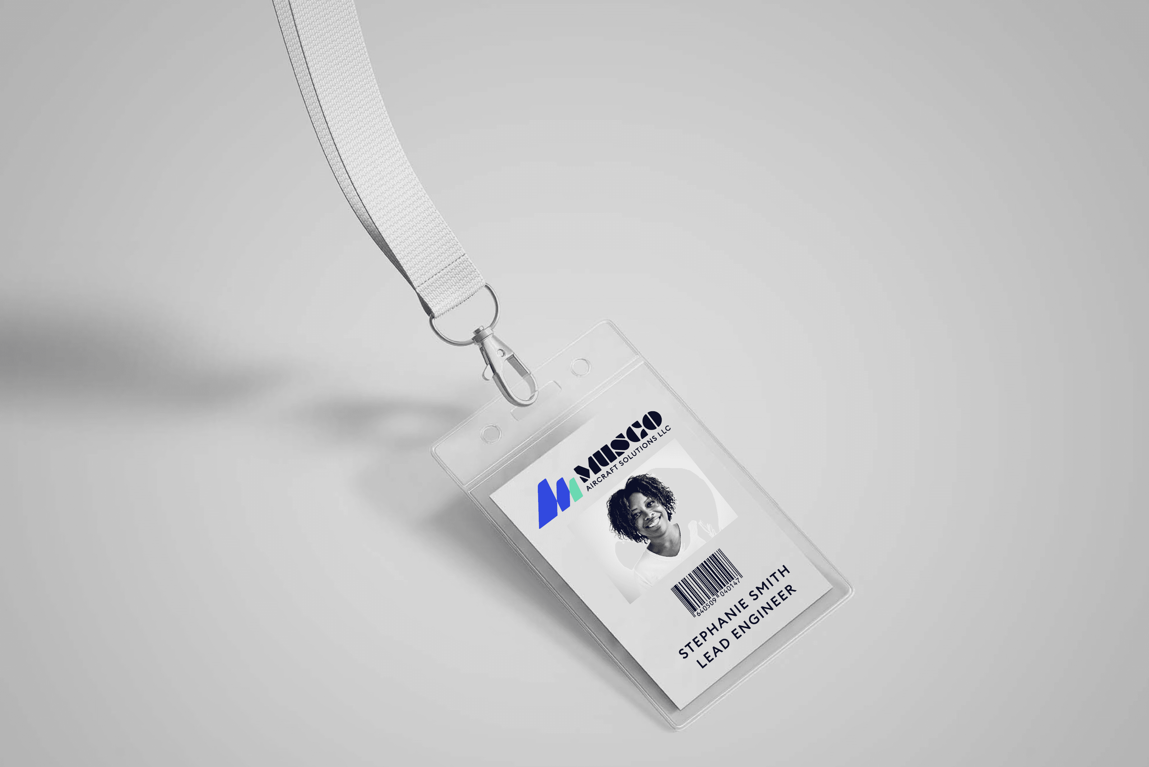 Graphic design mockup of an engineering nametag for Musco Aircraft Solutions — modern, geometric wordmark logo with a clean brandmark with a clean sans serif typography, designed by Will Lefkovich.