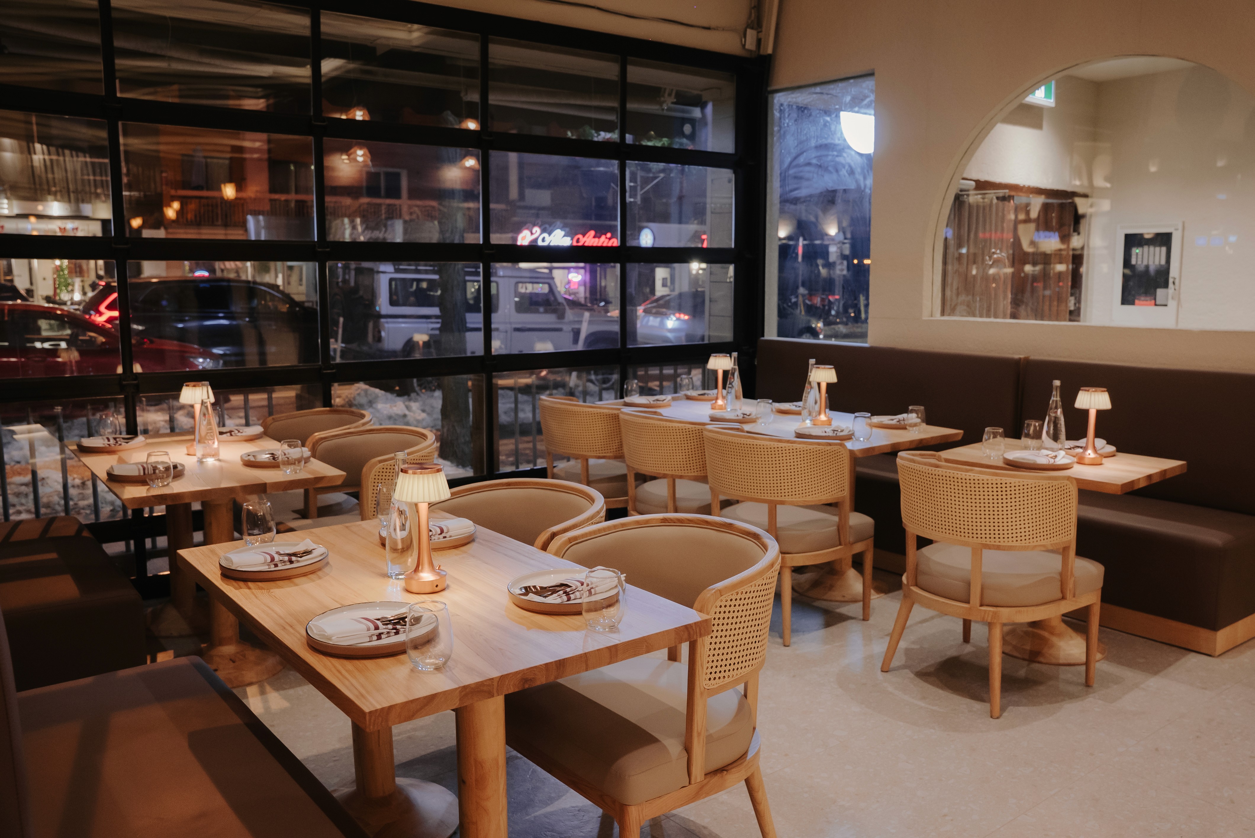 Modern Indian restaurant in Toronto with cozy window-side seating, candle-lit tables, and a refined brunch-to-dinner dining atmosphere at Dhoom.