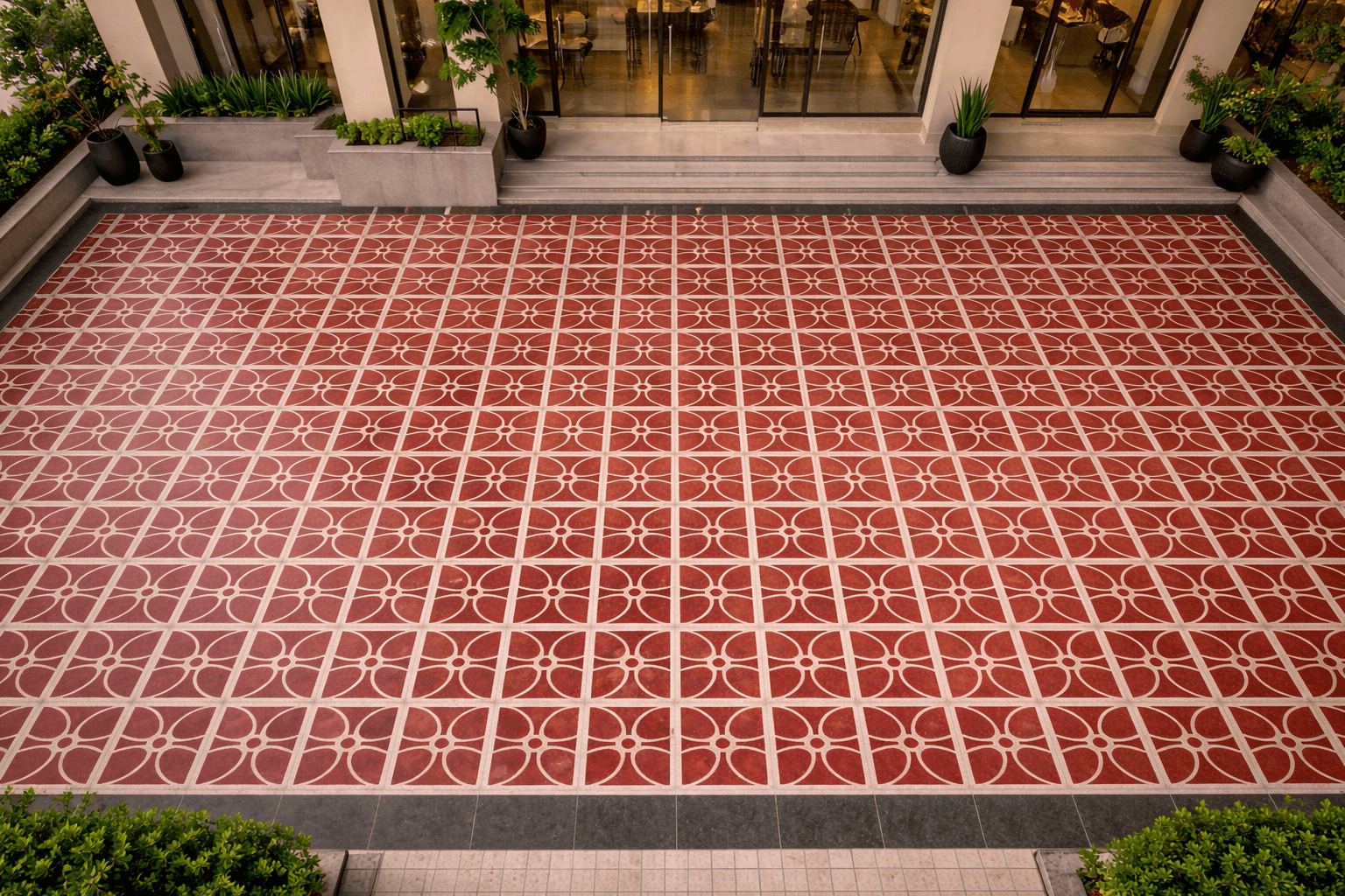 Phoenix stone tiles applied in expansive outdoor flooring with symmetrical patterned design