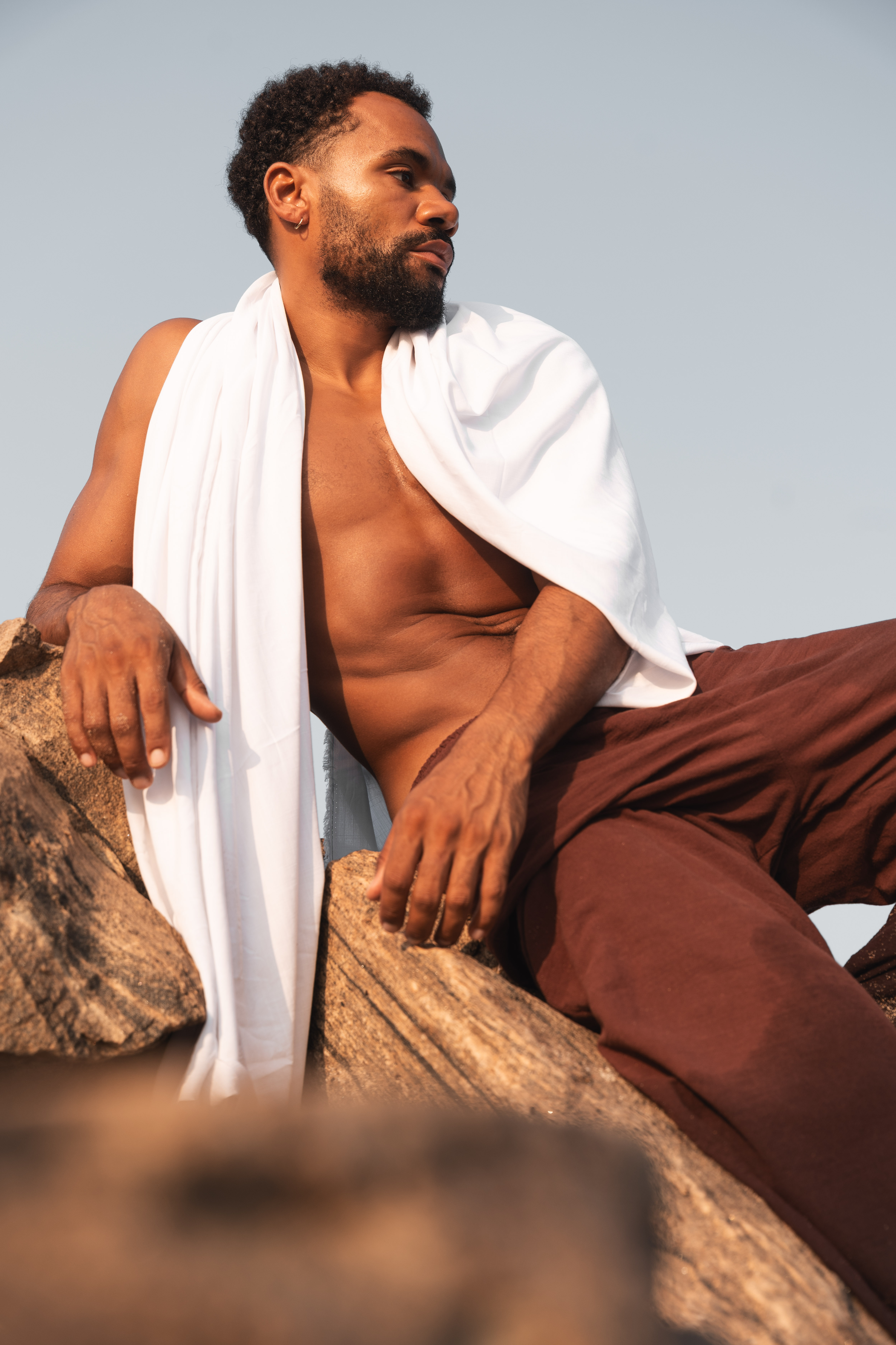 Close up of a girls face laying in the sand on her arm