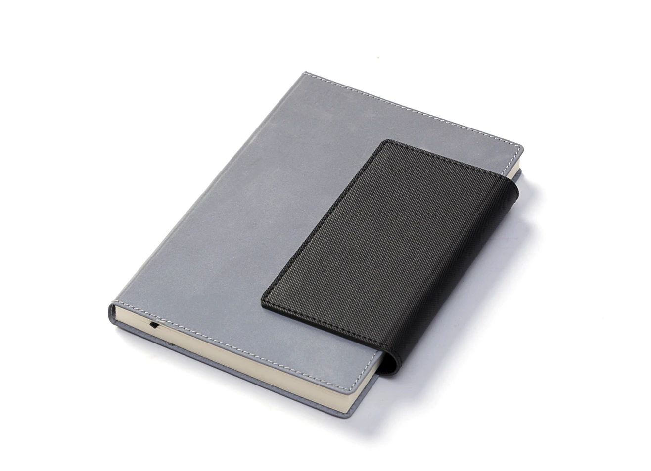 Closed grey notebook with black magnetic flap.