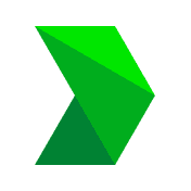 A smiling person with curly hair sits at a desk, looking at a laptop against a dark background.