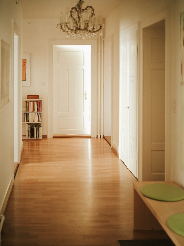 Minimalist room with potted trees and round wall mirrors
