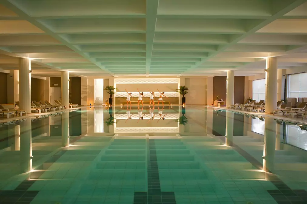 A man stading with Surfboard