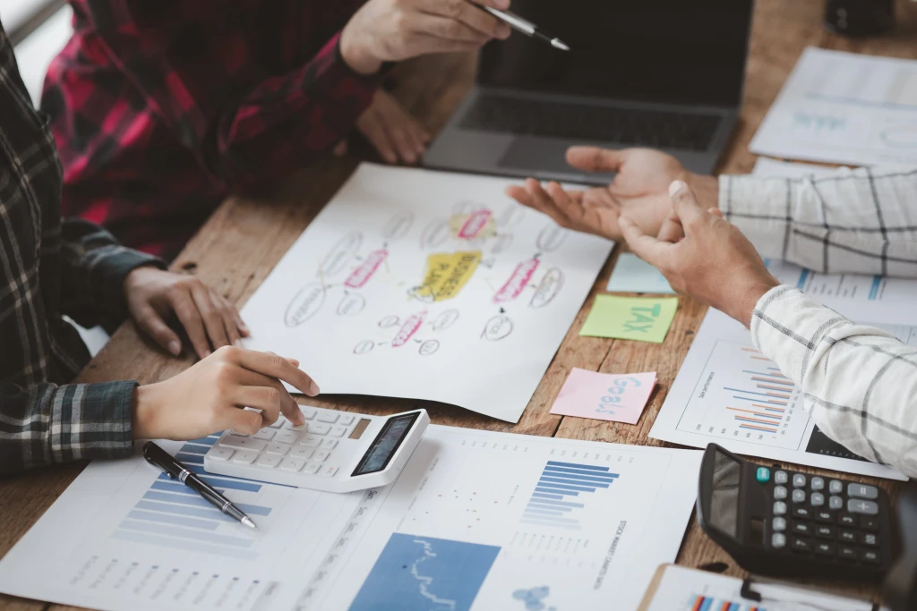 Business professionals creating a buisness plan accross a table