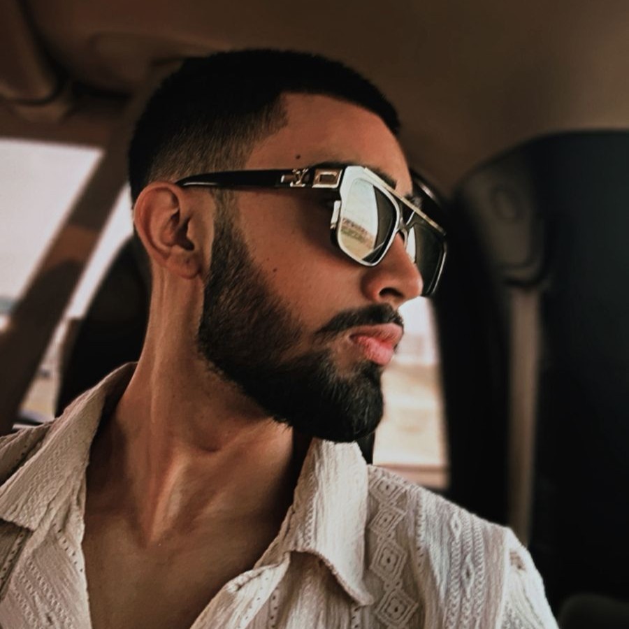 Nischal Poudel in louis vuitton sunglasses looking sideways looking challanging and masculine