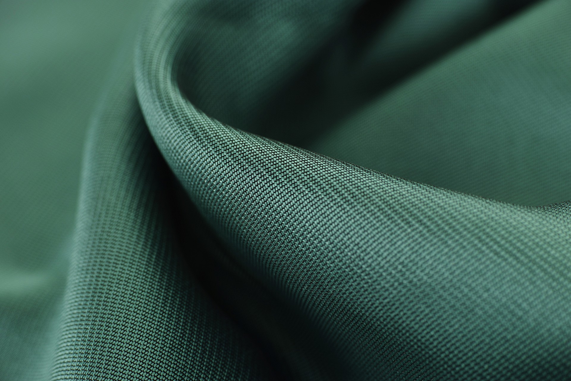 A textured green fabric with close-knit details.