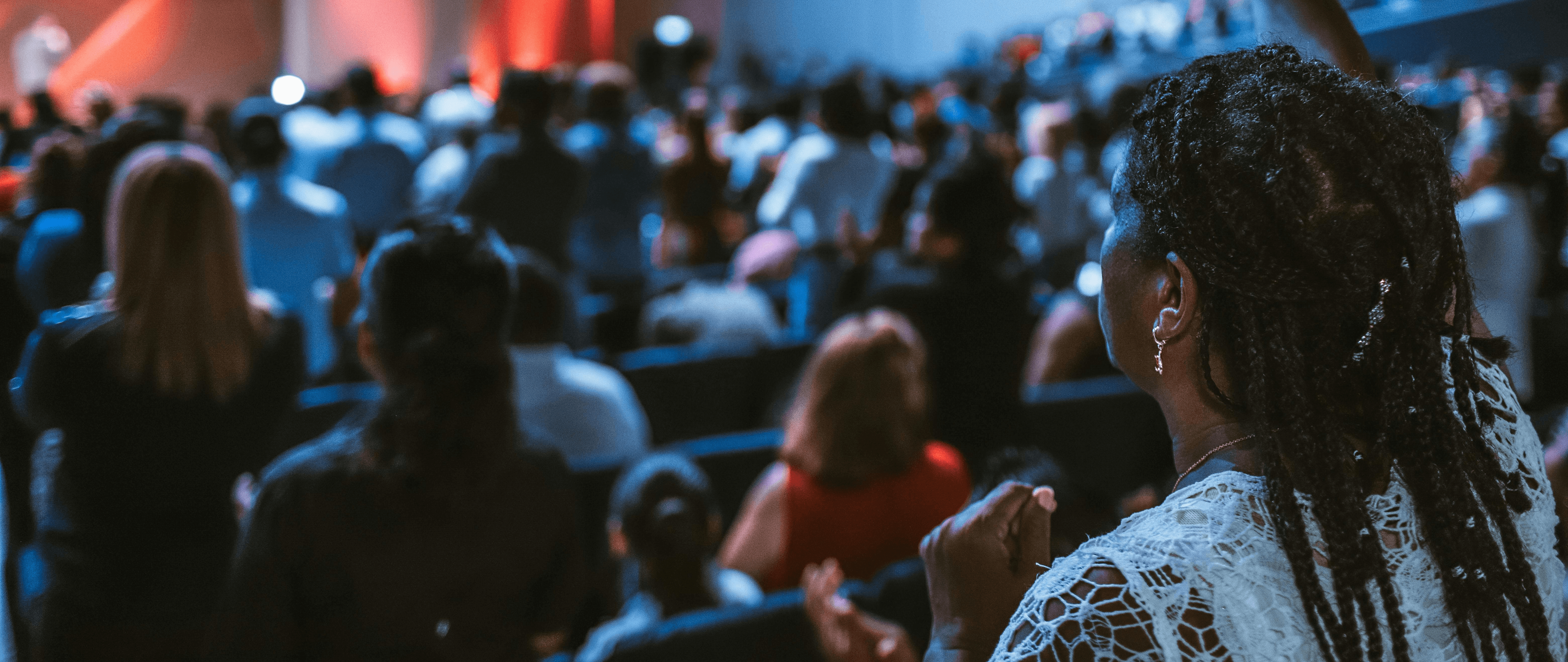 woman holding a phone and man looking at the phone. both are smiling