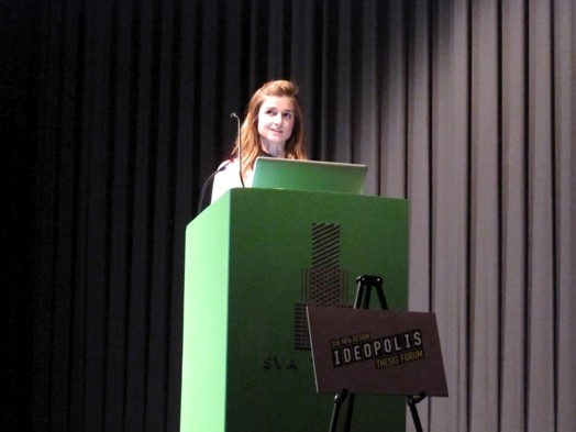 a woman at the green stand is giving a speech in the Ideopolis exhibition