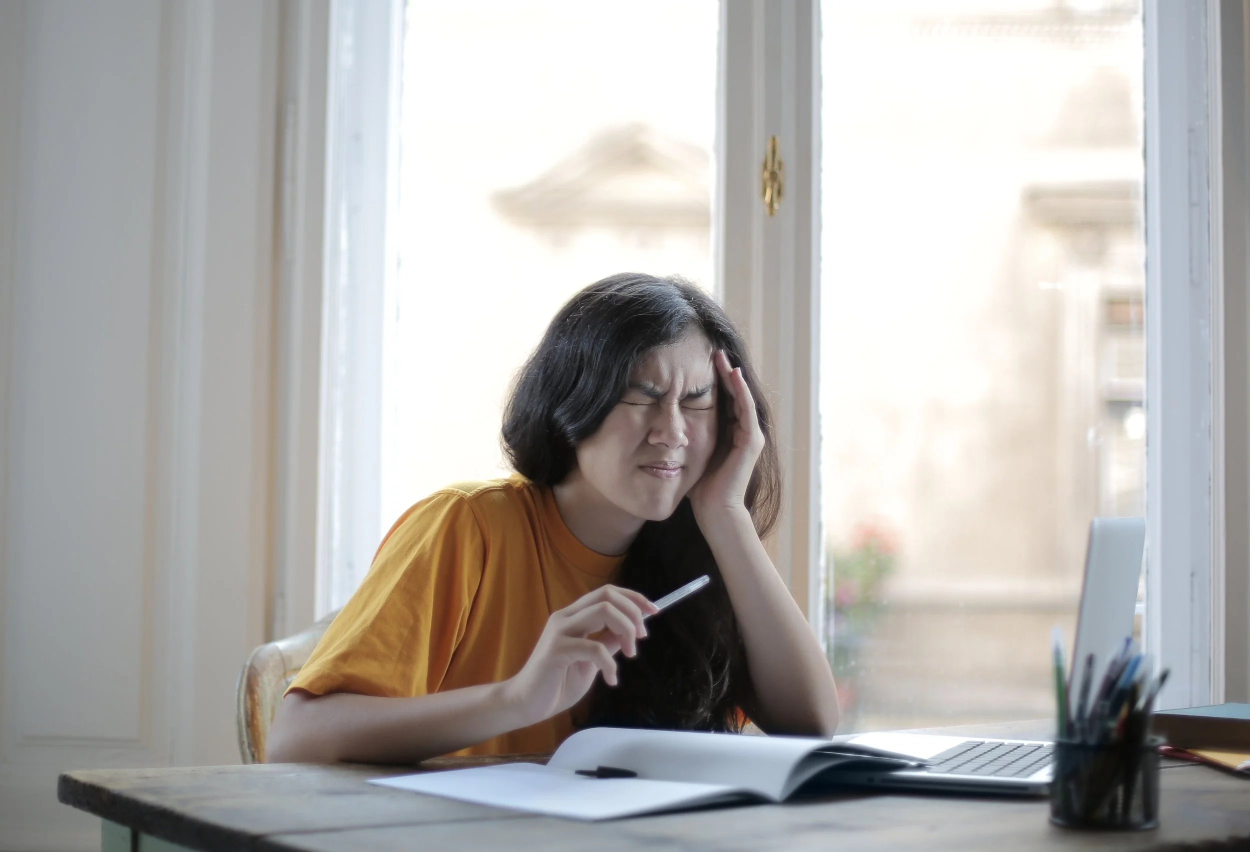 A frustrated woman sits with her documents