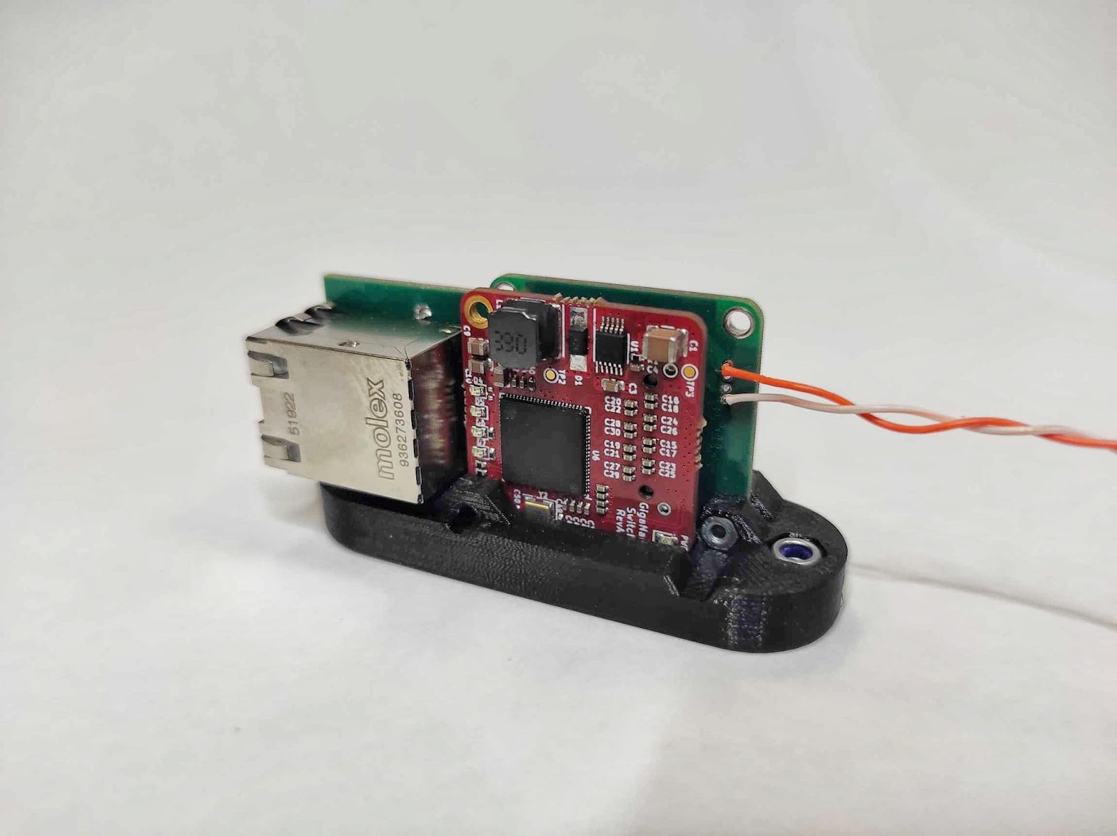 GigaBlox Nano stacked on its custom daughterboard with RJ45 magnetics and single twisted-pair uplink