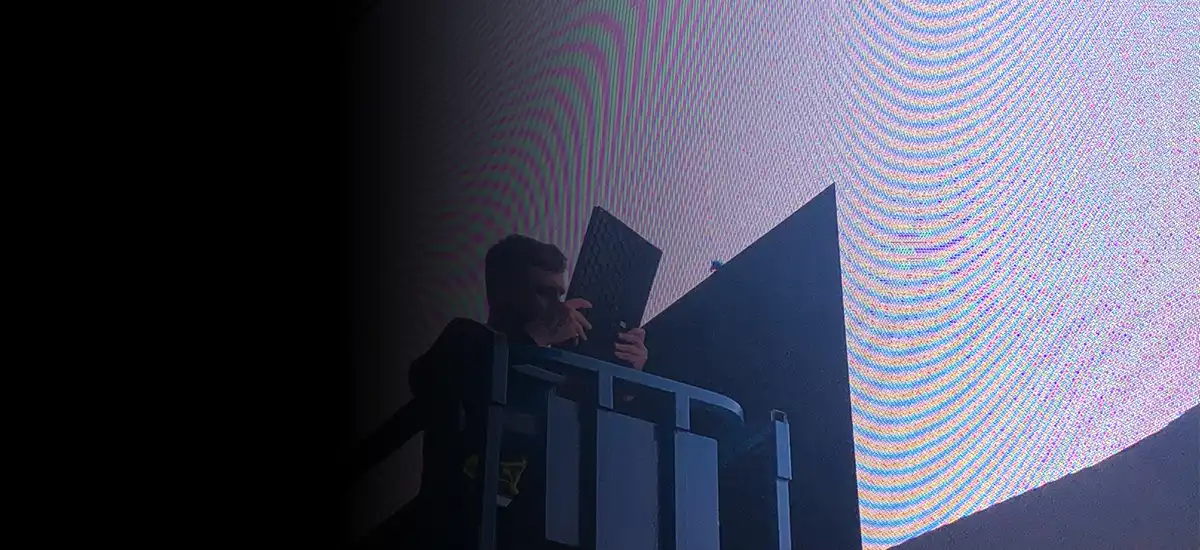 Engineer servicing modules on a large commercial LED display